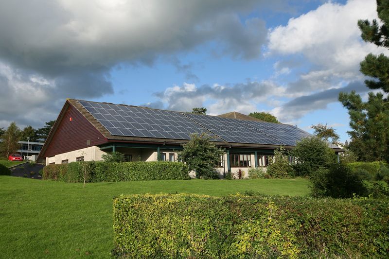 Long single-storey building with a large solar array along the full length of its roof