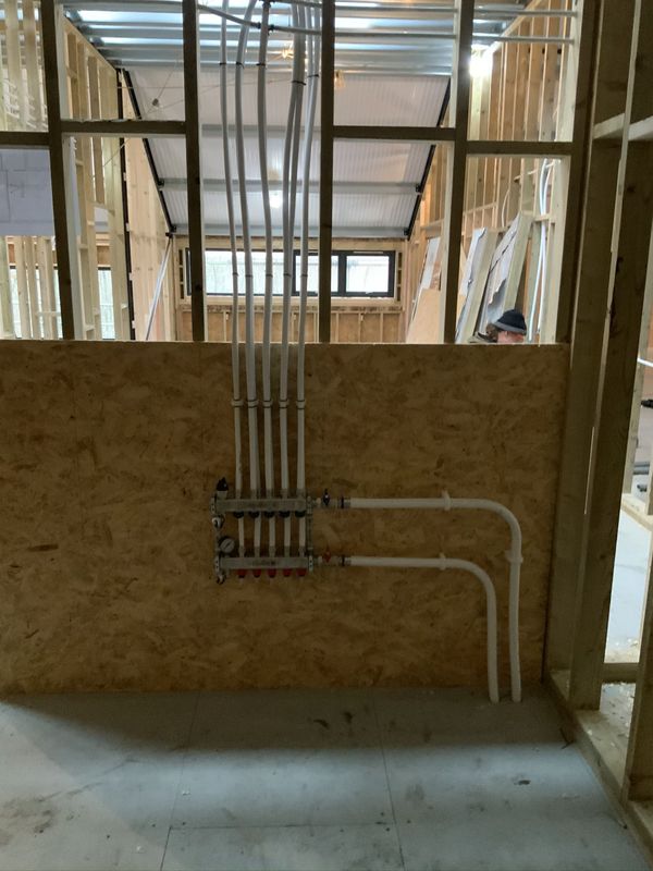 Pipe runs through the timber frame of the building